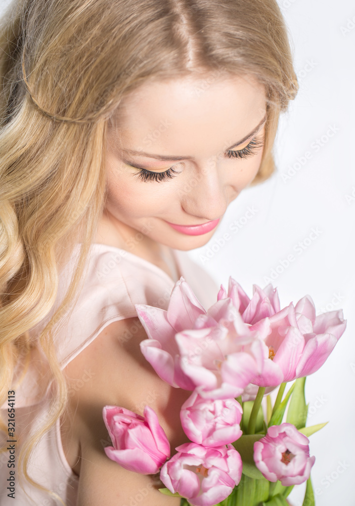 Luxurious blonde with a bouquet of tulips Luxurious blonde with a bouquet of tulips