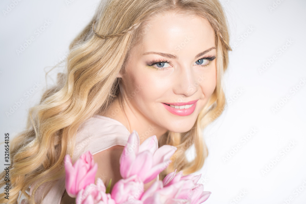 Luxurious blonde with a bouquet of tulips