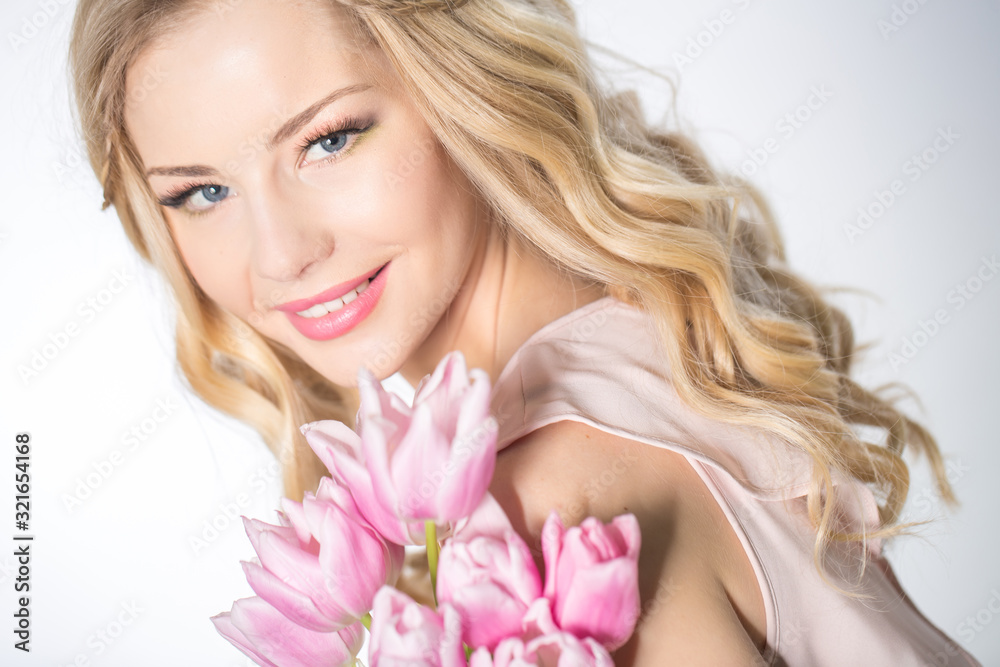 Luxurious blonde with a bouquet of tulips Luxurious blonde with a bouquet of tulips