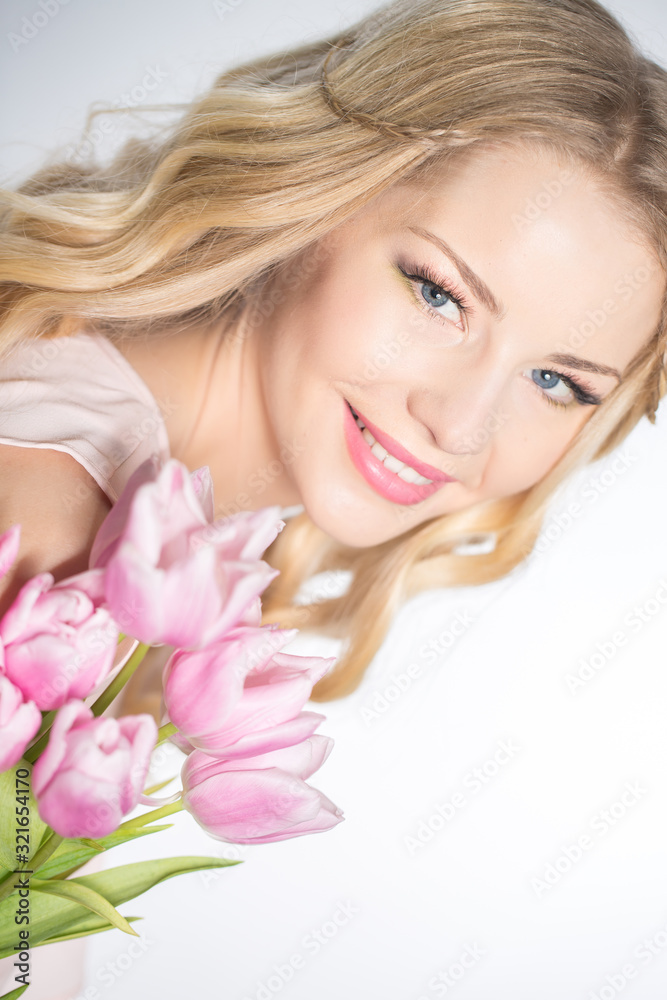 Luxurious blonde with a bouquet of tulips Luxurious blonde with a bouquet of tulips