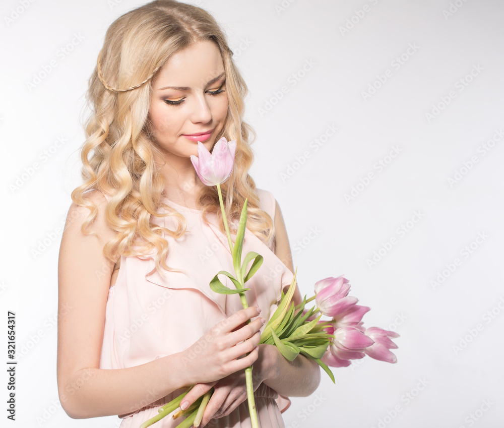 Luxurious blonde with a bouquet of tulips Luxurious blonde with a bouquet of tulips