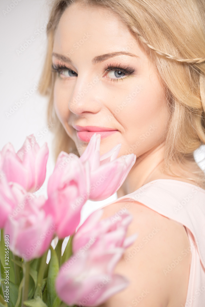 Luxurious blonde with a bouquet of tulips Luxurious blonde with a bouquet of tulips