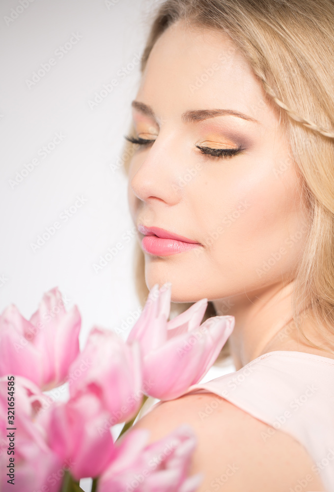 Luxurious blonde with a bouquet of tulips Luxurious blonde with a bouquet of tulips