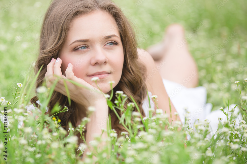 Beautiful young girl lying on the grass Beautiful young girl lying on the grass