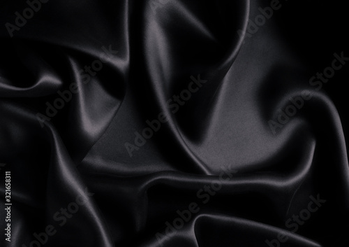 Satin black silk background, close-up