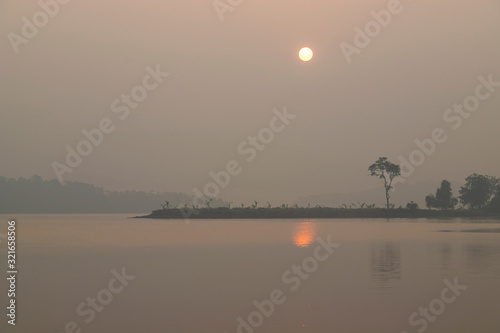 Beautiful sunrise above the lake at Vandri lake in Maharasthra India photo