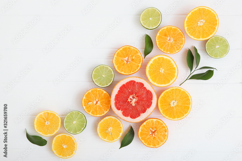 Different citrus and juicy slices on a light background top view. Place to insert text. Different citrus and juicy slices on a light background top view. Place to insert text.