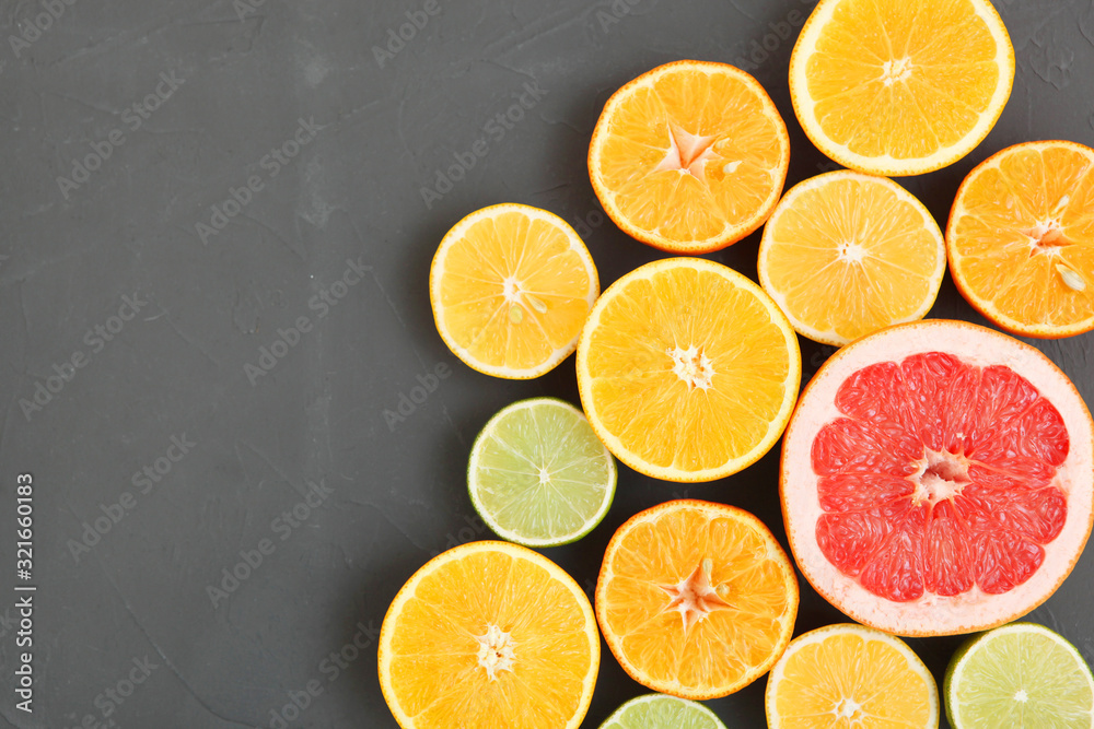 Different citrus and juicy slices on a colored background top view. Place to insert text. Different citrus and juicy slices on a colored background top view. Place to insert text.