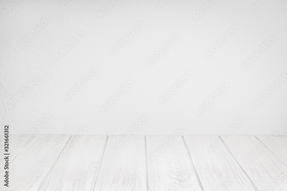 Empty Wood Table On white washed Textured wall. White background for composition. Copy space