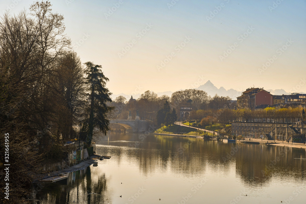 Elevated view of Po river with the peak of Monviso Alpine mountain in the background and the Murazzi riverside in winter, Turin, Piedmont, Italy Elevated view of Po river with the peak of Monviso Alpine mountain in the background and the Murazzi riverside in winter, Turin, Piedmont, Italy