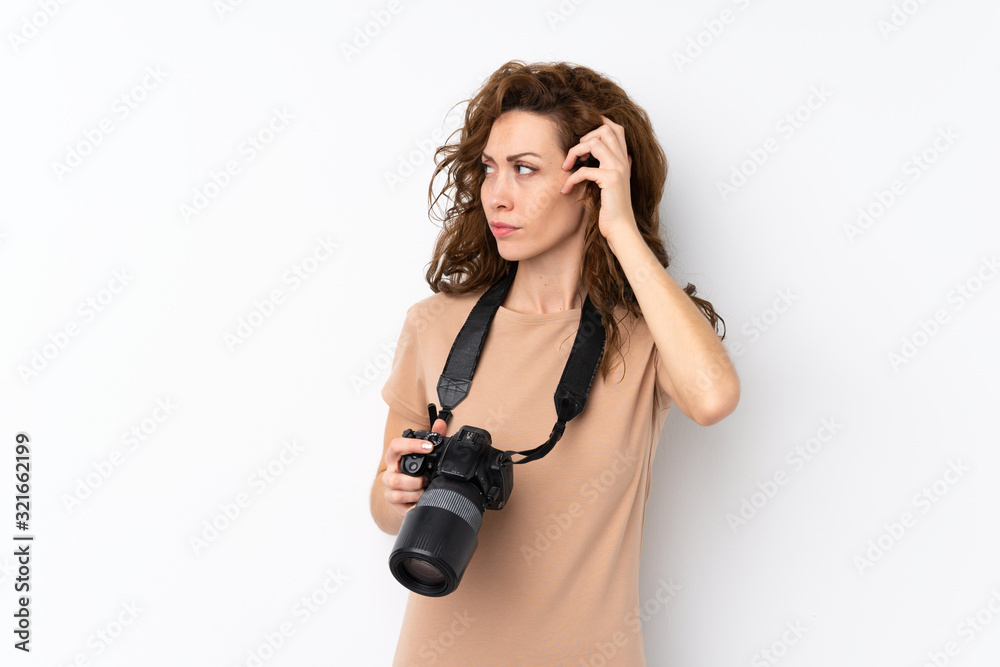 Young pretty woman over isolated background with a professional camera and thinking Young pretty woman over isolated background with a professional camera and thinking