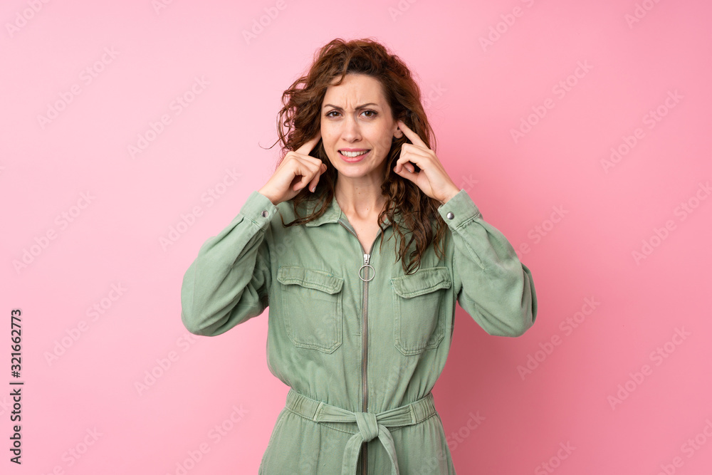 Young pretty woman over isolated pink background frustrated and covering ears Young pretty woman over isolated pink background frustrated and covering ears