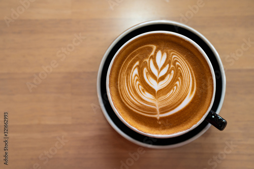 Beautiful of Latte art coffee cup on wooden table, Flat lay