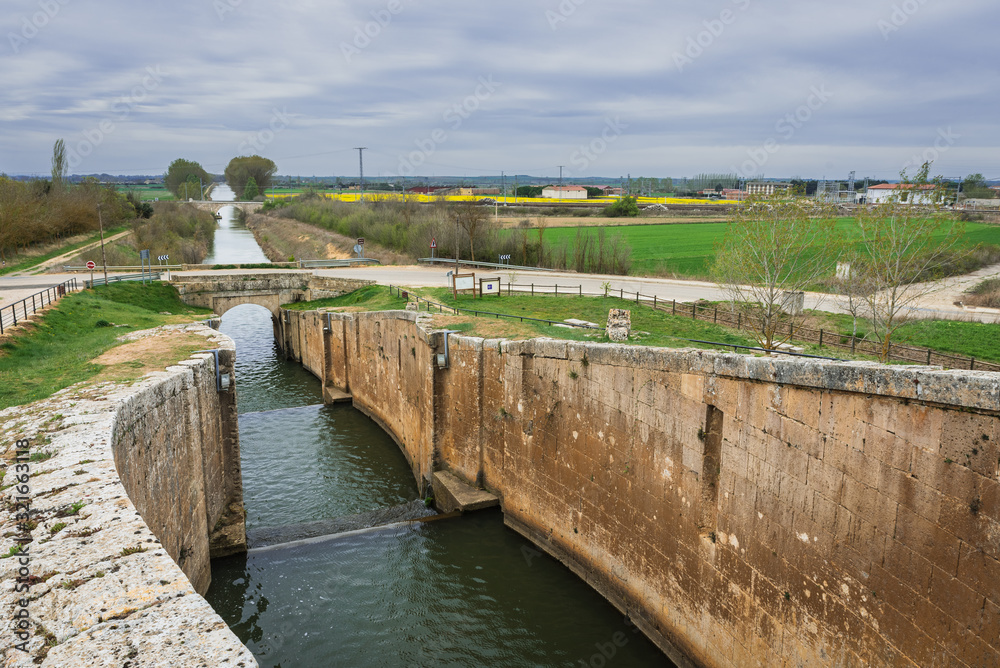 lock gates of the canal de castilla, castile channel, in a cloudy day, palencia, spain