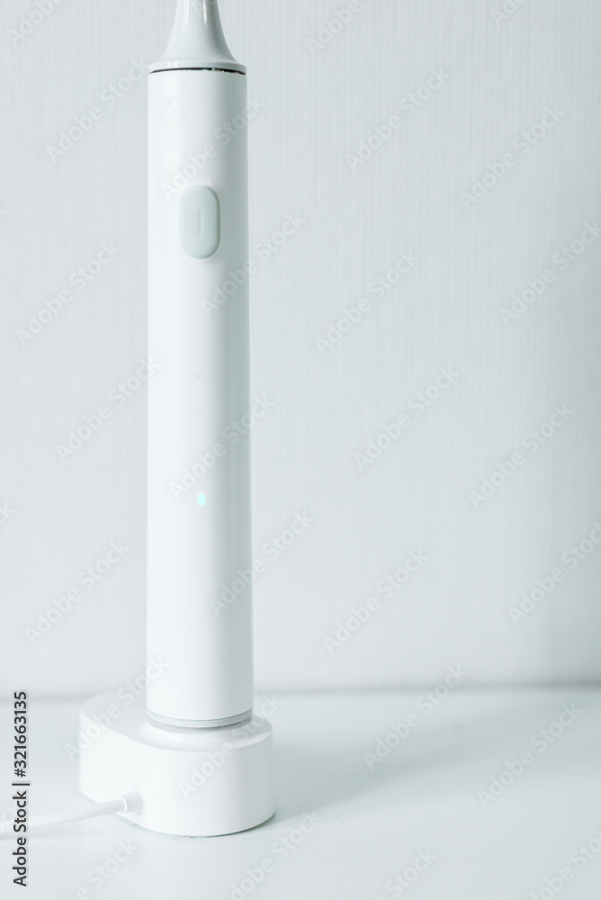 Electric toothbrush on a light background. Electric toothbrush on a light background.