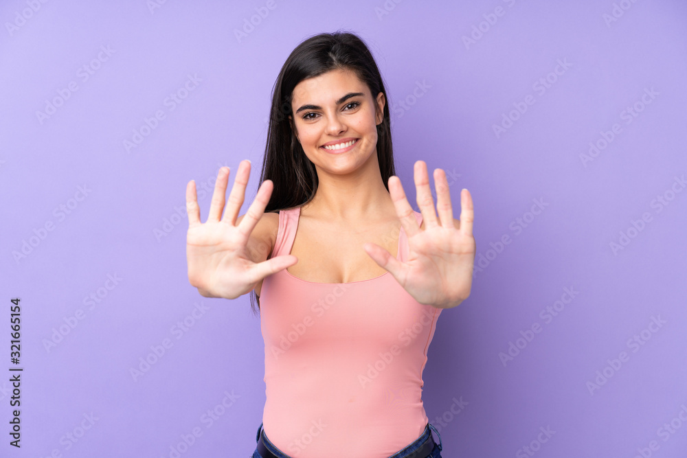 Young woman over isolated purple background counting ten with fingers Young woman over isolated purple background counting ten with fingers
