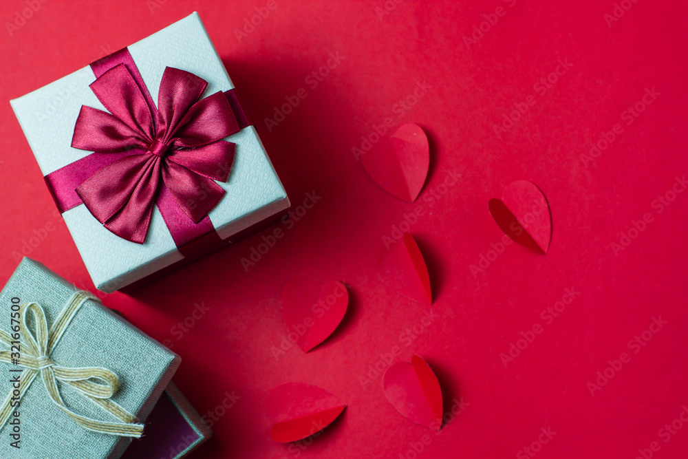 Gift boxes and hearts on a red background
