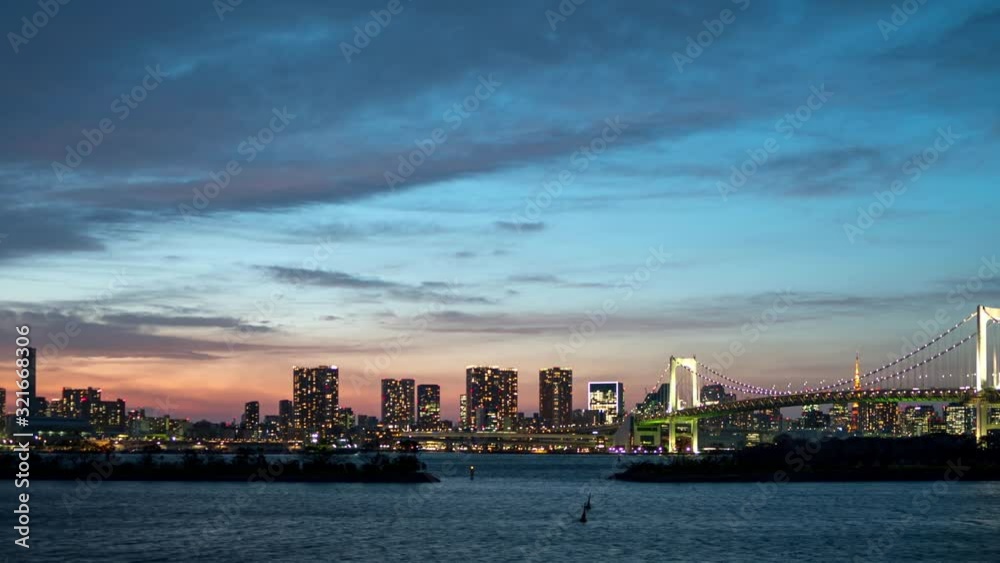 Amazing timelapse of Tokyo skyline with Rainbow Bridge and Tokyo bay at evening after sunset. Amazing timelapse of Tokyo skyline with Rainbow Bridge and Tokyo bay at evening after sunset.