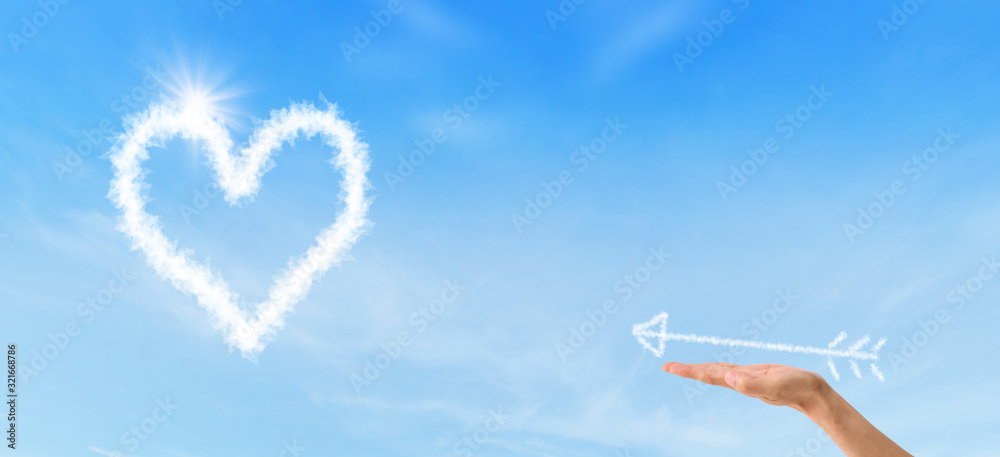 Valentines Day Concept : Female hand holding white arrow and shooting to white heart. Valentines Day Concept : Female hand holding white arrow and shooting to white heart.