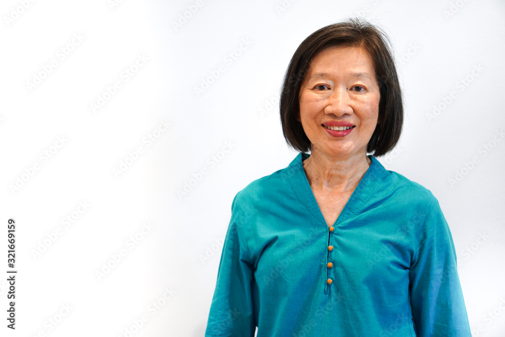 An old beautiful asian woman with smiling face in blue blouse on the white background An old beautiful asian woman with smiling face in blue blouse on the white background