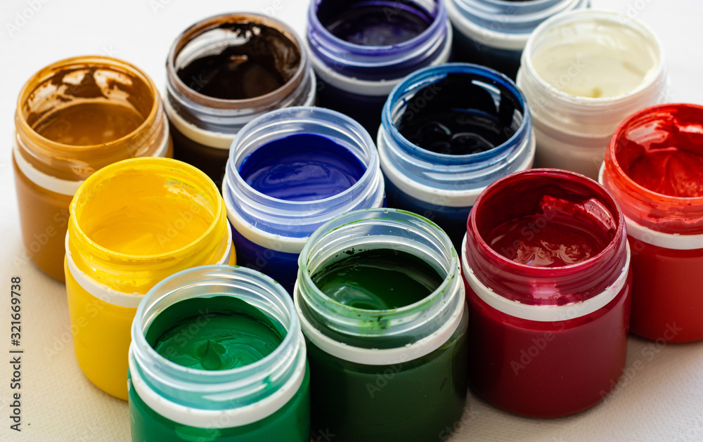 Tempera paints on the table in a workshop, selective focus, close up Tempera paints on the table in a workshop, selective focus, close up