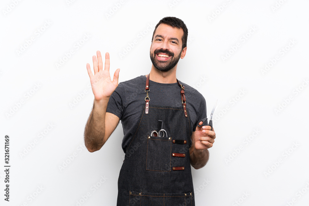 Barber man in an apron saluting with hand with happy expression Barber man in an apron saluting with hand with happy expression