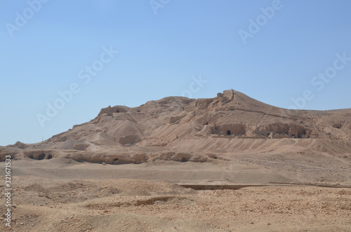The Mortuary Temple of Hatshepesut, also known as the Djeser-Djeseru, is a mortuary temple of Ancient Egypt located in Upper Egypt. Desert and ruined area around the temple.