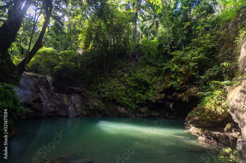 Hidden in jungles Ingkumhan waterfalls, popular tourist attraction in Dimiao, Bohol, Philippines