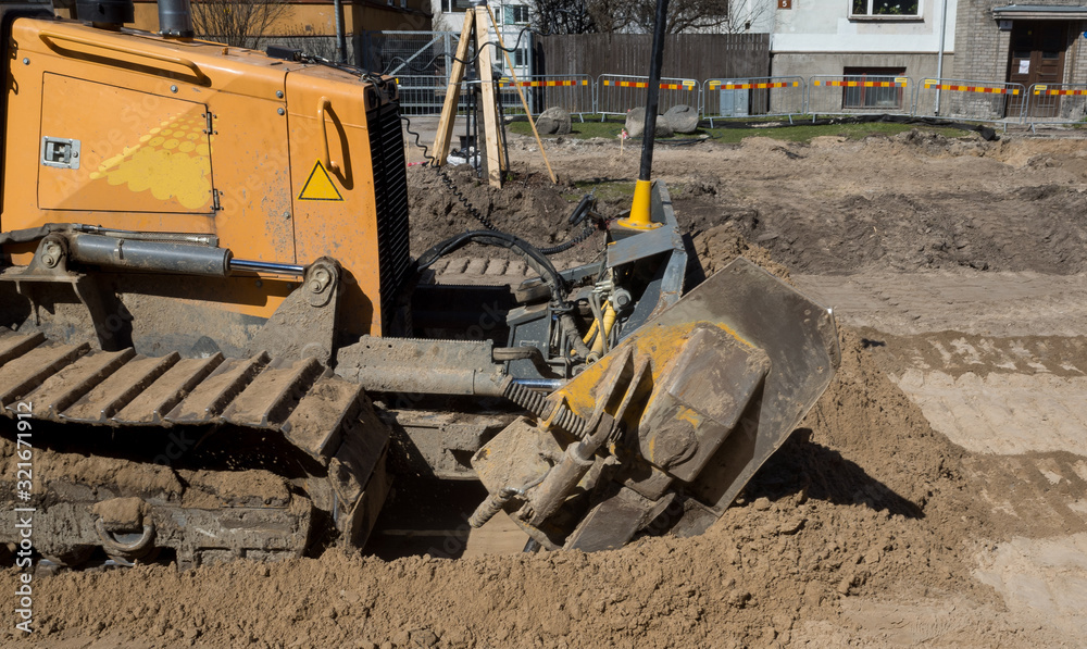 A bulldozer carries out earthworks during the reconstruction of the street.