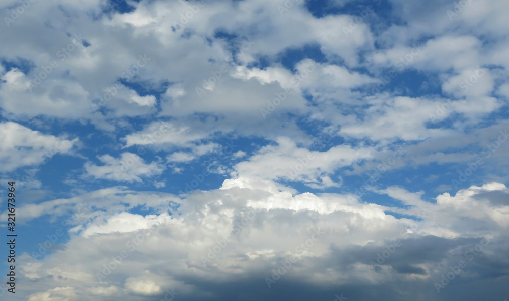 Blue sky with fluffy clouds, natural background Blue sky with fluffy clouds, natural background