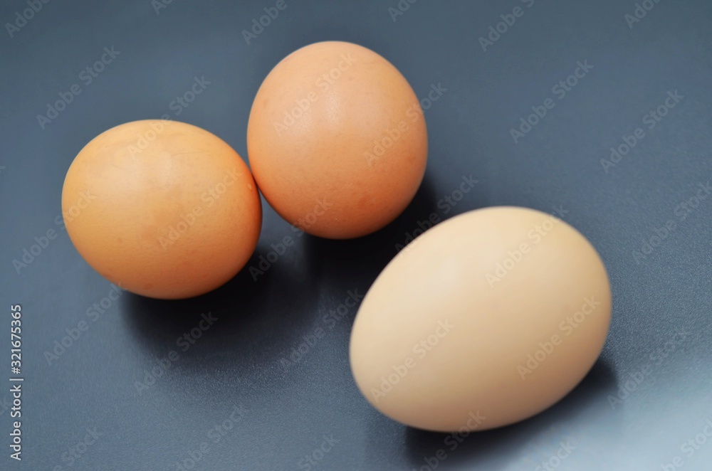 Three eggs on a black indoor background Three eggs on a black indoor background