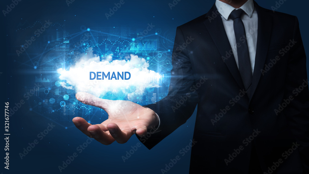 Hand of Businessman holding DEMAND inscription, successful business concept Hand of Businessman holding DEMAND inscription, successful business concept