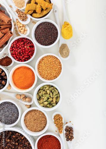 Spices and herbs flat lay, white background, top view.