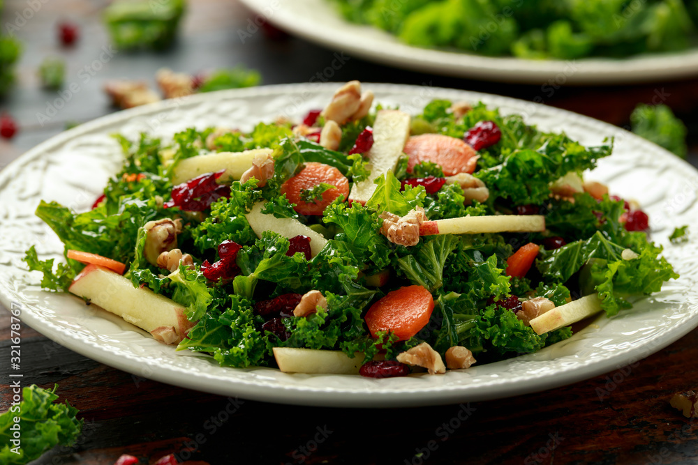 Kale salad with dried cranberry, carrots, walnuts and apple. healthy vegan food. Kale salad with dried cranberry, carrots, walnuts and apple. healthy vegan food.