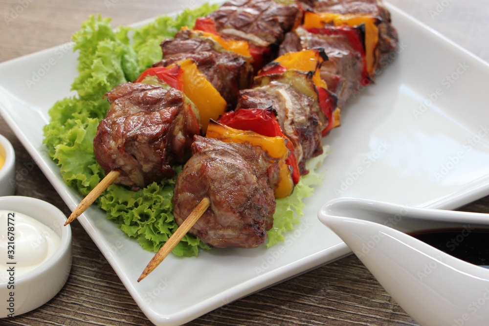 Delicious pork kebab with vegetables and bacon