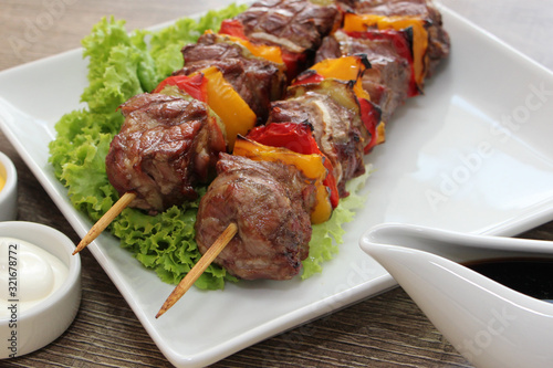 Delicious pork kebab with vegetables and bacon