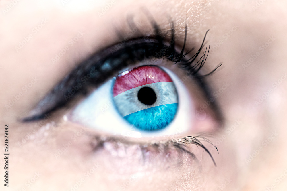 Flag of luxembourg reflects in a woman blue eye - election, sport, hope, young, generation, pride, dream, emotion, independance	