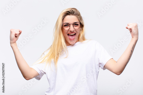 Photography young pretty blonde woman feeling happy, surprised and proud, shouting and celeb