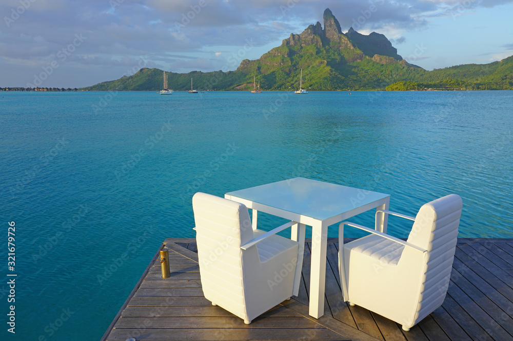 Table and chairs with a view of the Mont Otemanu and the Bora Bora lagoon in French Polynesia