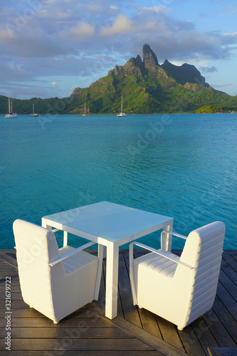 Table and chairs with a view of the Mont Otemanu and the Bora Bora lagoon in French Polynesia © eqroy