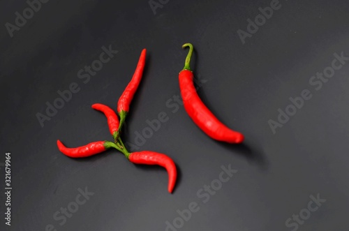 Red peppers on a black indoor background