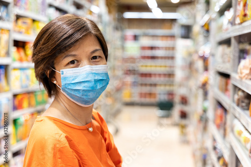 Asian women with face mask for protection against influenza virus shopping