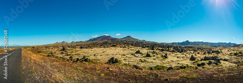 Panoramic view over ancient lava field and lonely road nearby, Snaefellsjoekull National Park, Iceland