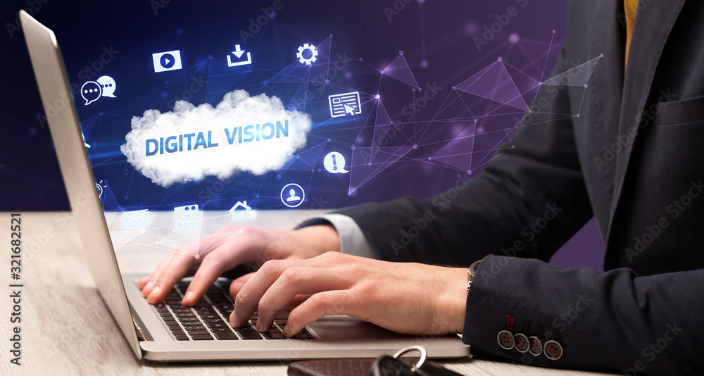 Businessman working on laptop with DIGITAL VISION inscription, modern technology concept Businessman working on laptop with DIGITAL VISION inscription, modern technology concept