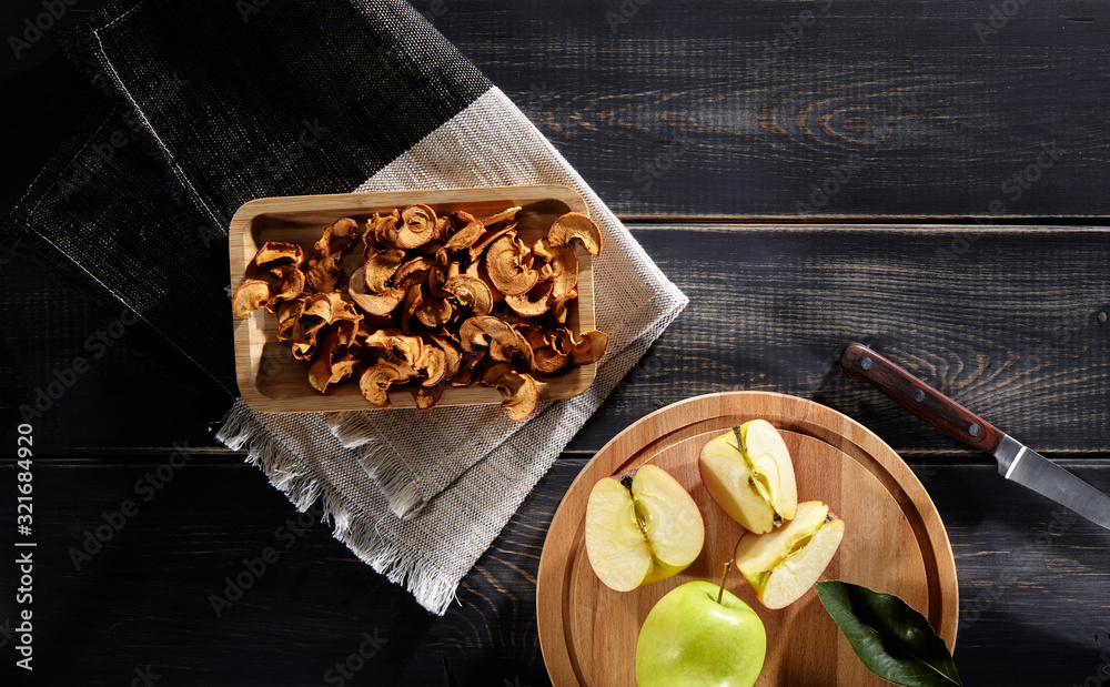 Fototapeta premium dried and fresh apples on a wooden table in morning light