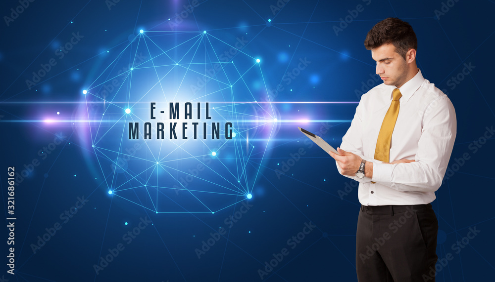 Businessman thinking about security solutions with E-MAIL MARKETING inscription Businessman thinking about security solutions with E-MAIL MARKETING inscription