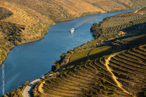 Cruise ship in Douro river and Alto Douro vineyards and landscape - UNESCO World Heritage