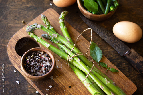 Fototapeta Naklejka Na Ścianę i Meble -  Superfood. Green asparagus on rustic wooden background. Copy space.
