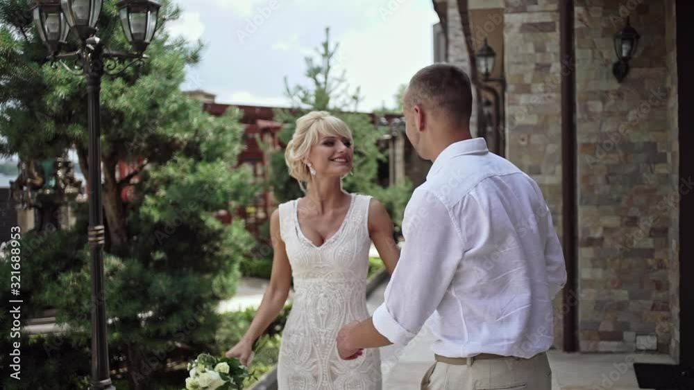 Happy newlywed couple dancing in yard Happy newlywed couple dancing in yard