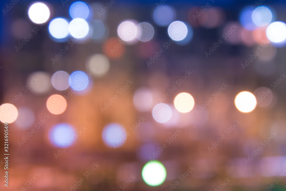 Abstract blurred background with copy space. Defocused night city with bokeh effect lanterns
